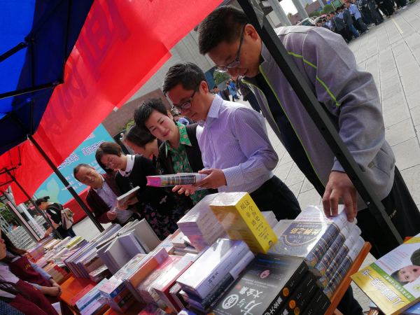 4月24日,在来凤县“倡导全民阅读 建设书香来凤”启动仪式上,县委常委、宣传部长管民桦(右二)查看新华书店展销精品图书